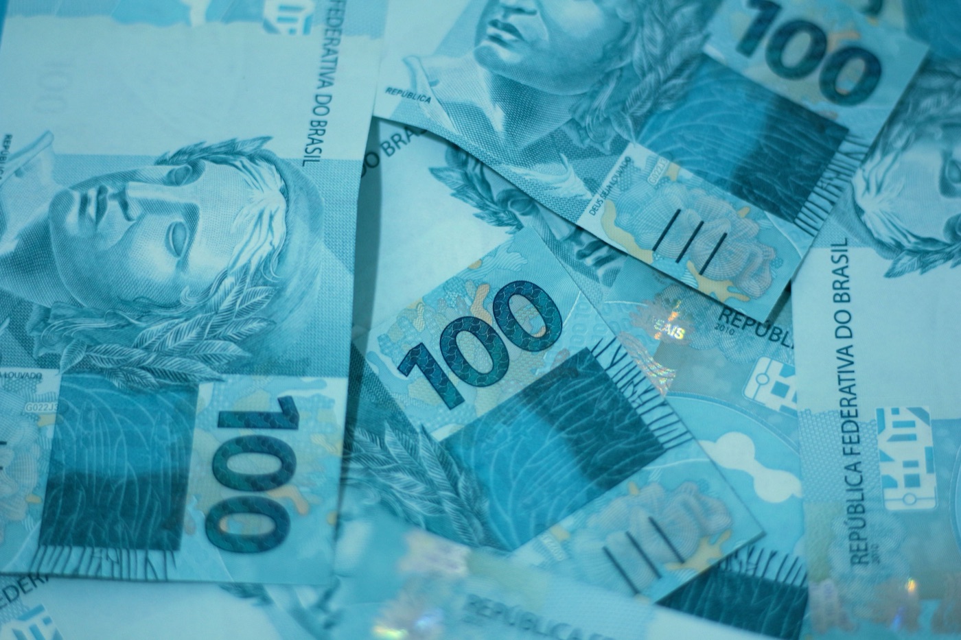Casal organizando o orçamento com notas de R$100